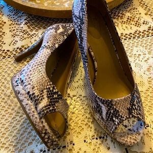 Snakeskin pattered open toe heels.